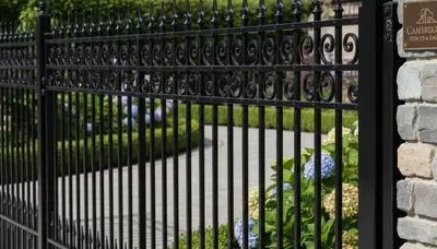 Ornamental black metal fence installation by Chop Chop Landscaping in Cambridge, MA for durable curb appeal